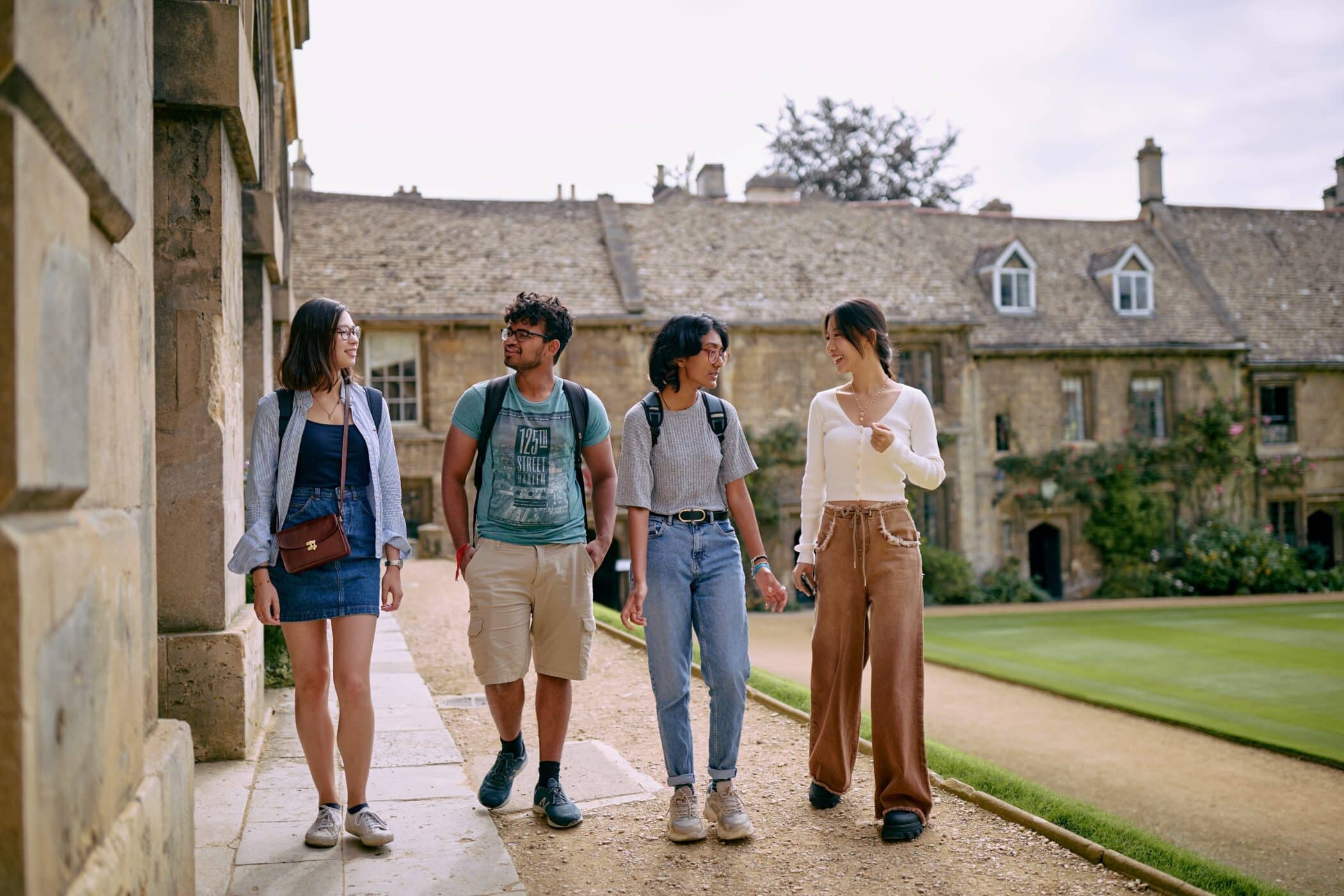 Four students walking in the quad