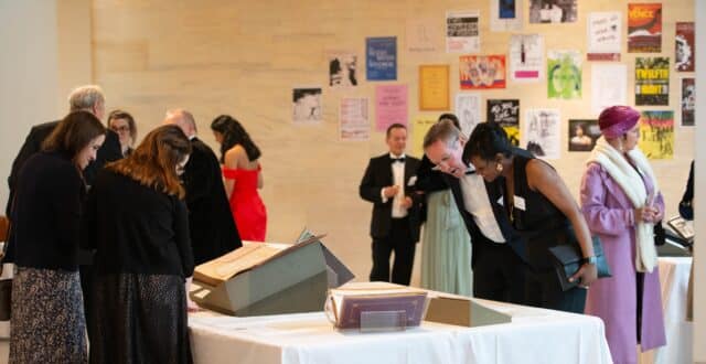 Guests looking at Archives display table