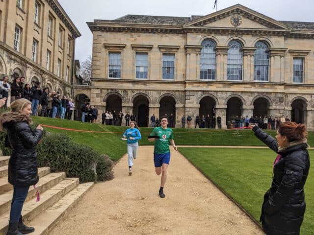 Students running in a pancake race in the quad